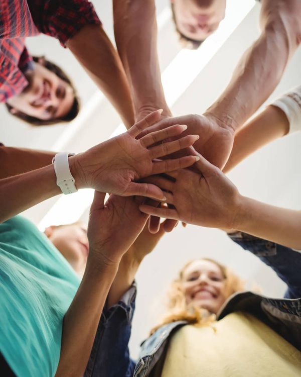 Team Huddle with Hands Joined Together
